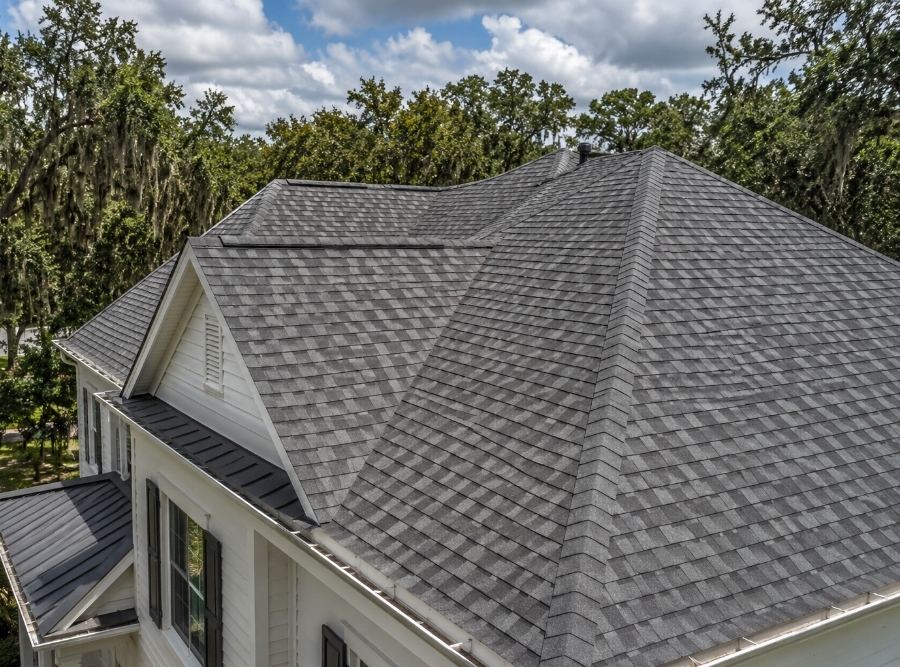 Architectural asphalt shingle roof on a Lowcountry home in Bluffton, SC surrounded by live oak trees.